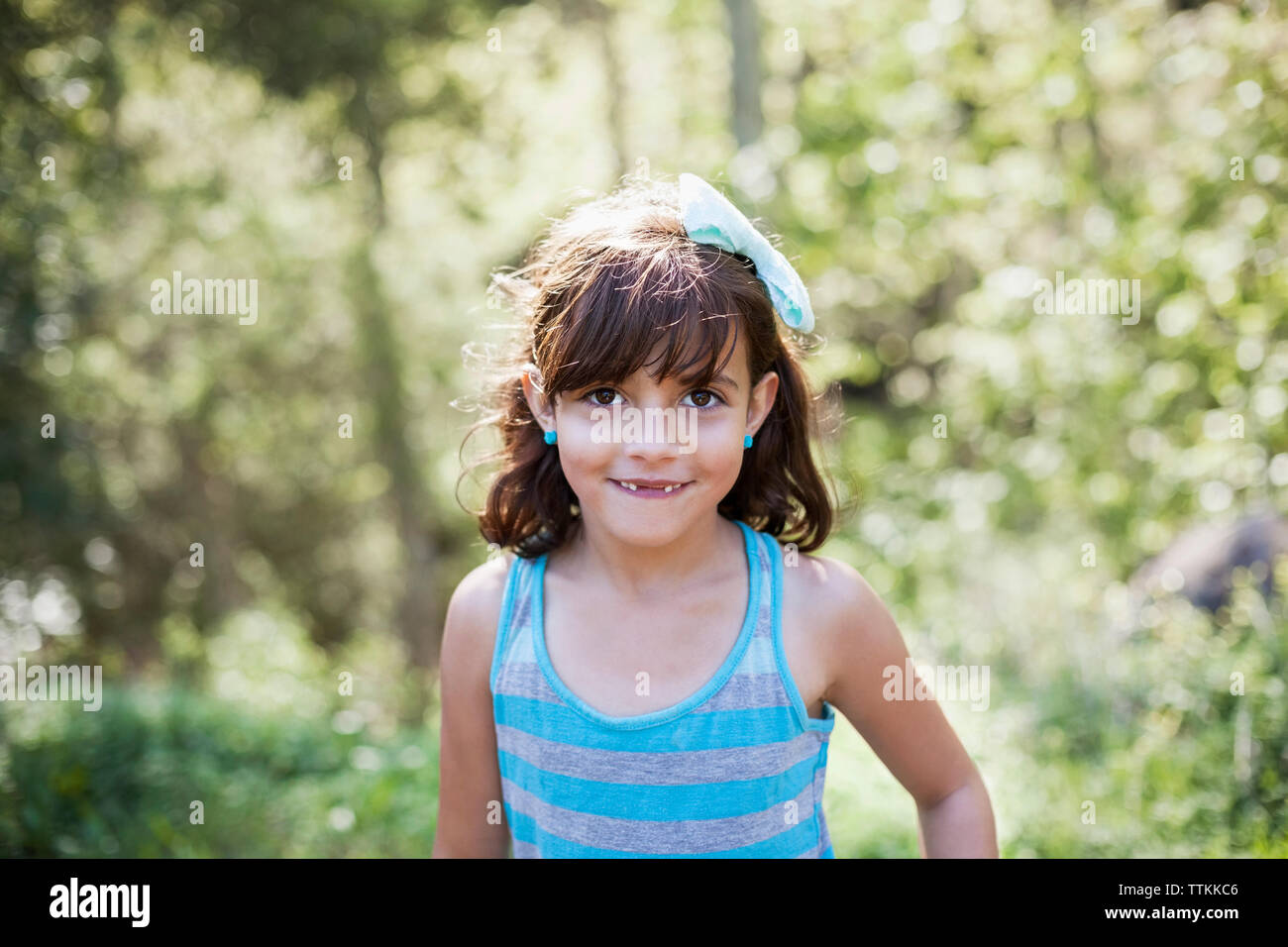 Portrait of cute girl smiling in forest Stock Photo - Alamy