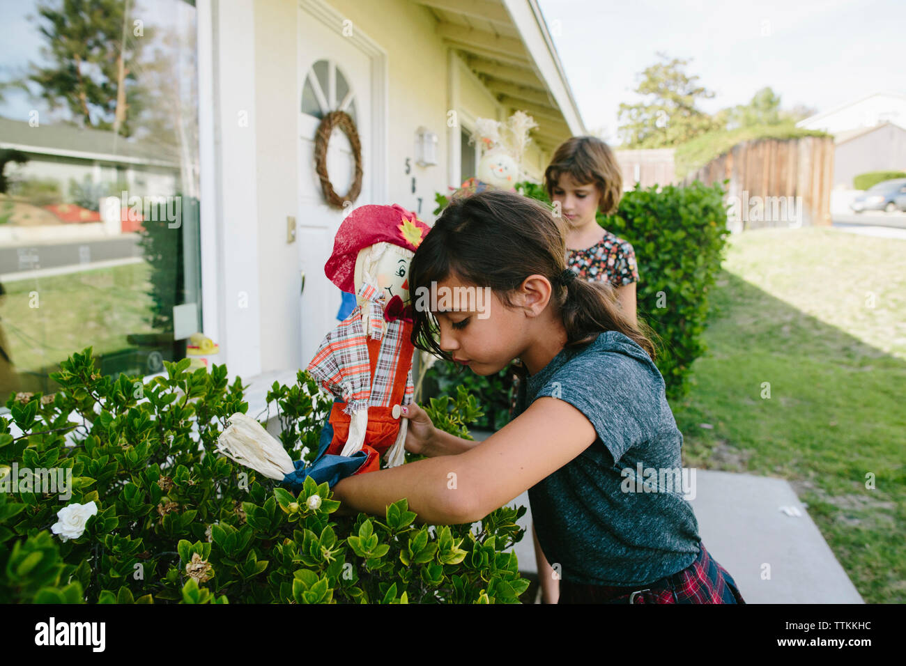 Sisters playing with toy in backyard Stock Photo