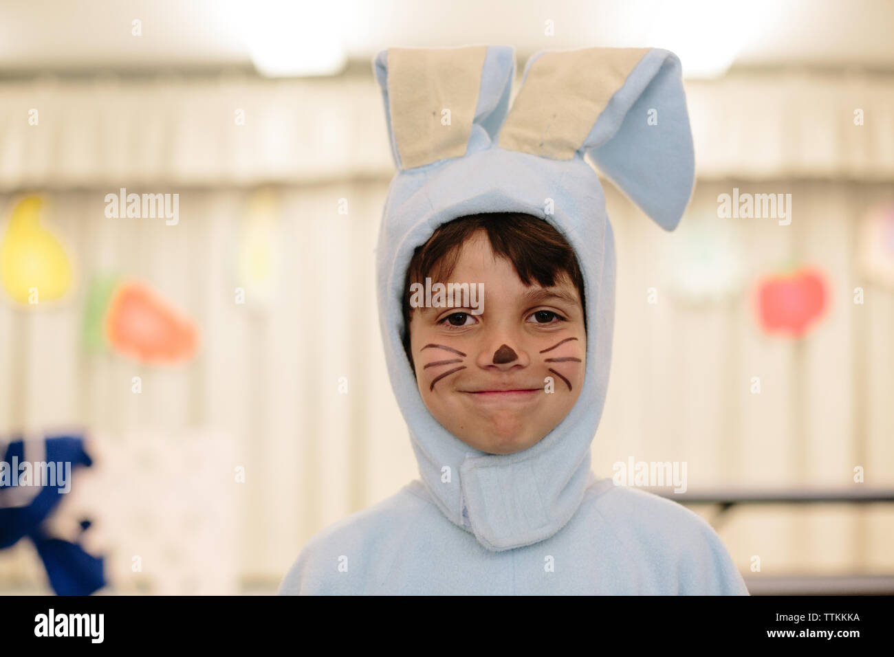 Portrait of cute boy in rabbit costume at home Stock Photo