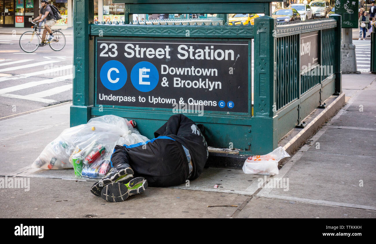 A homeless individual encamped outside a subway entrance in New York on Friday, June 14, 2019. (© Richard B. Levine) Stock Photo