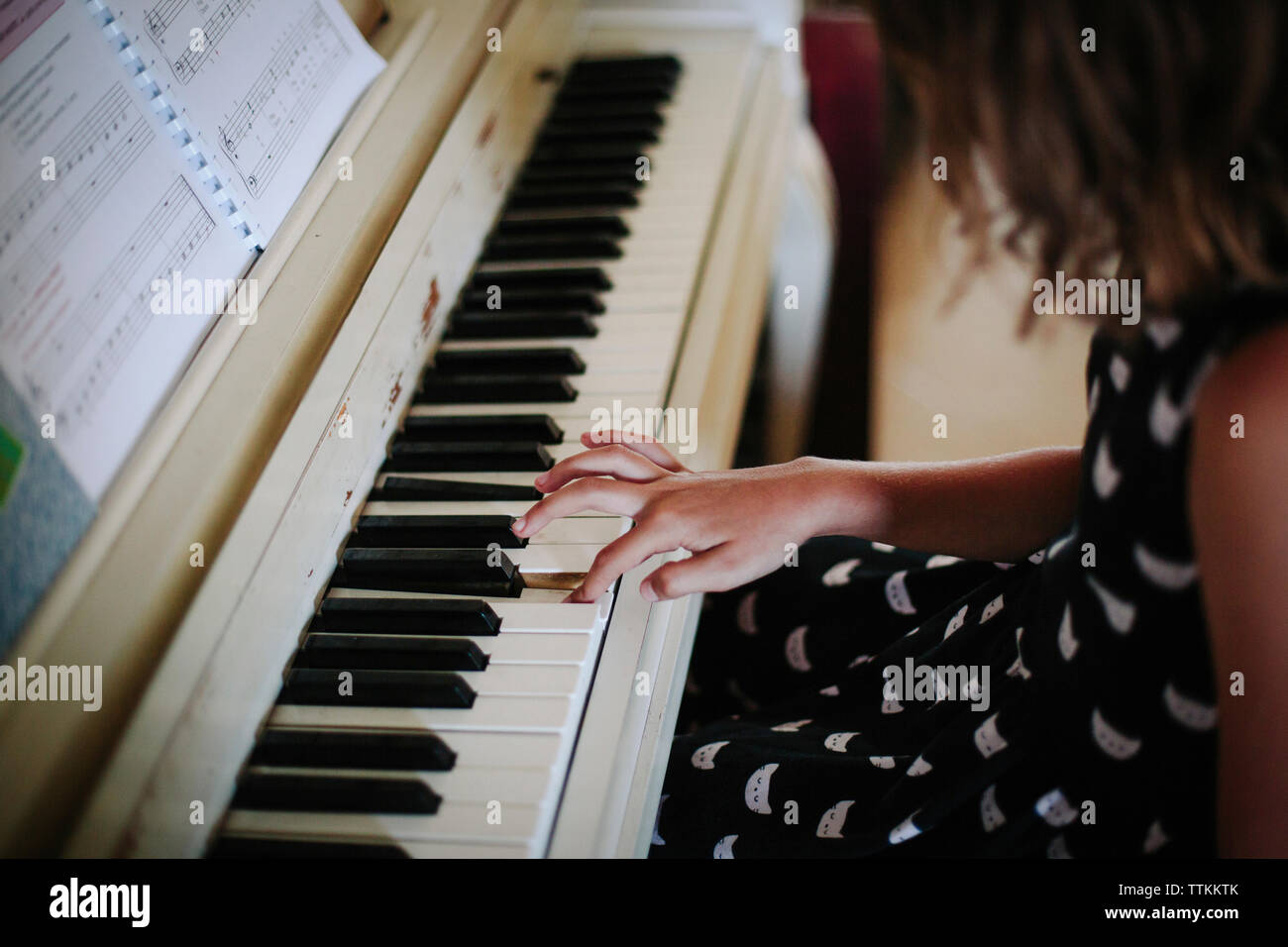 High angle view of girl playing piano at home Stock Photo