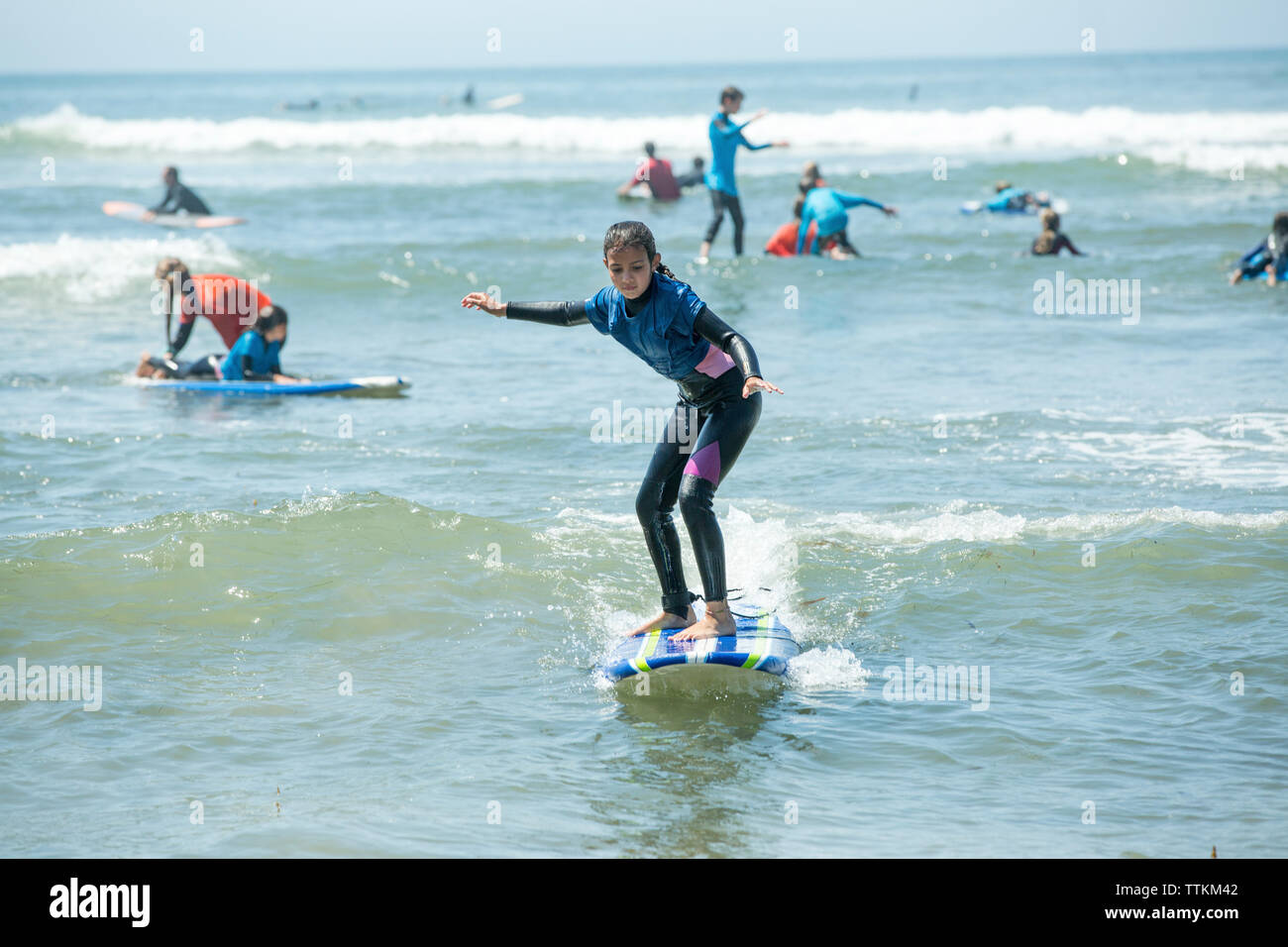 Full length of girl surfing on sea Stock Photo
