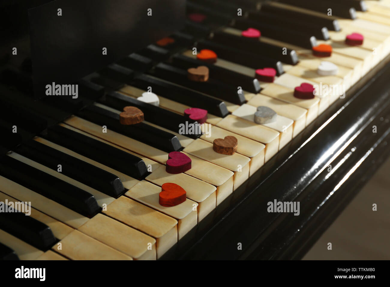 Colourful hearts on piano keys, close up Stock Photo