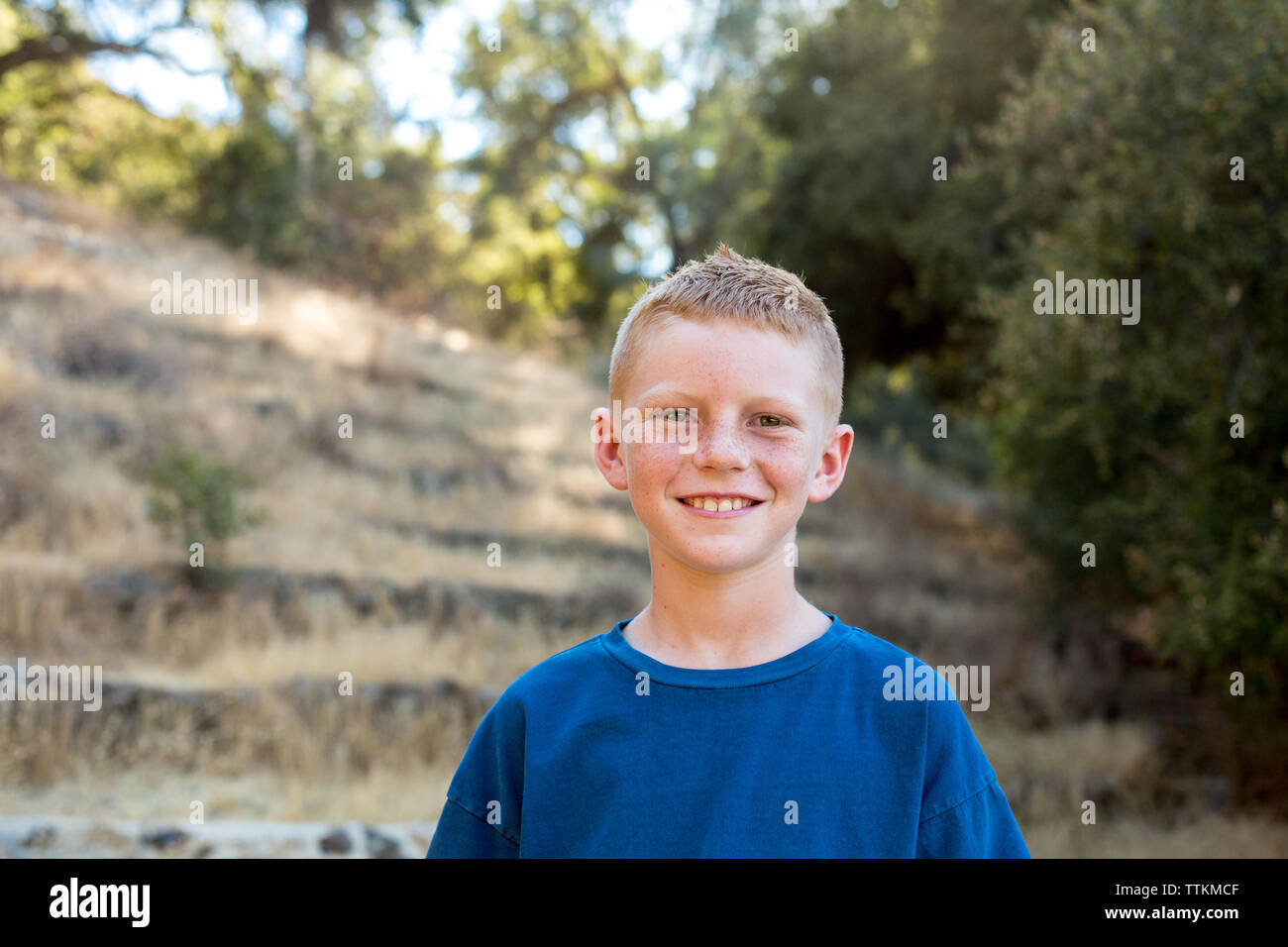 Portrait of a young boy out in nature smiling for the camera Stock ...