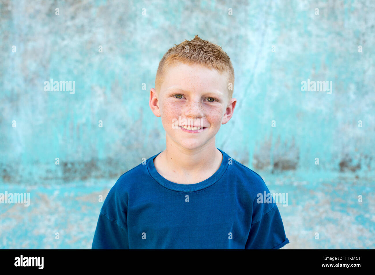 Portrait of a red head boy with a cool blue backdrop Stock Photo