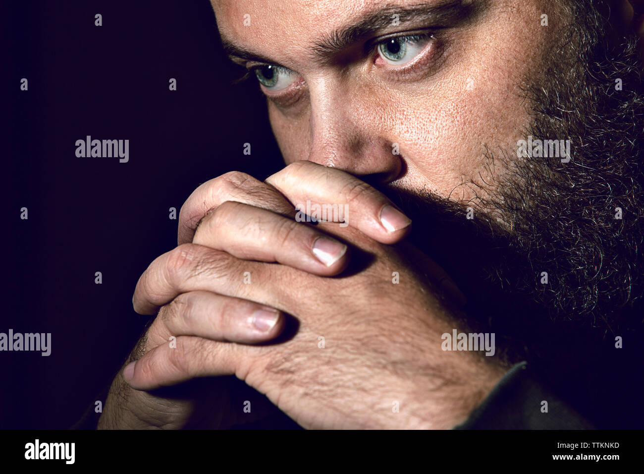 Close-up of serious man against black background Stock Photo
