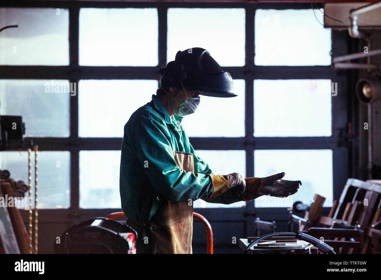 Man wearing protective workwear in workshop Stock Photo