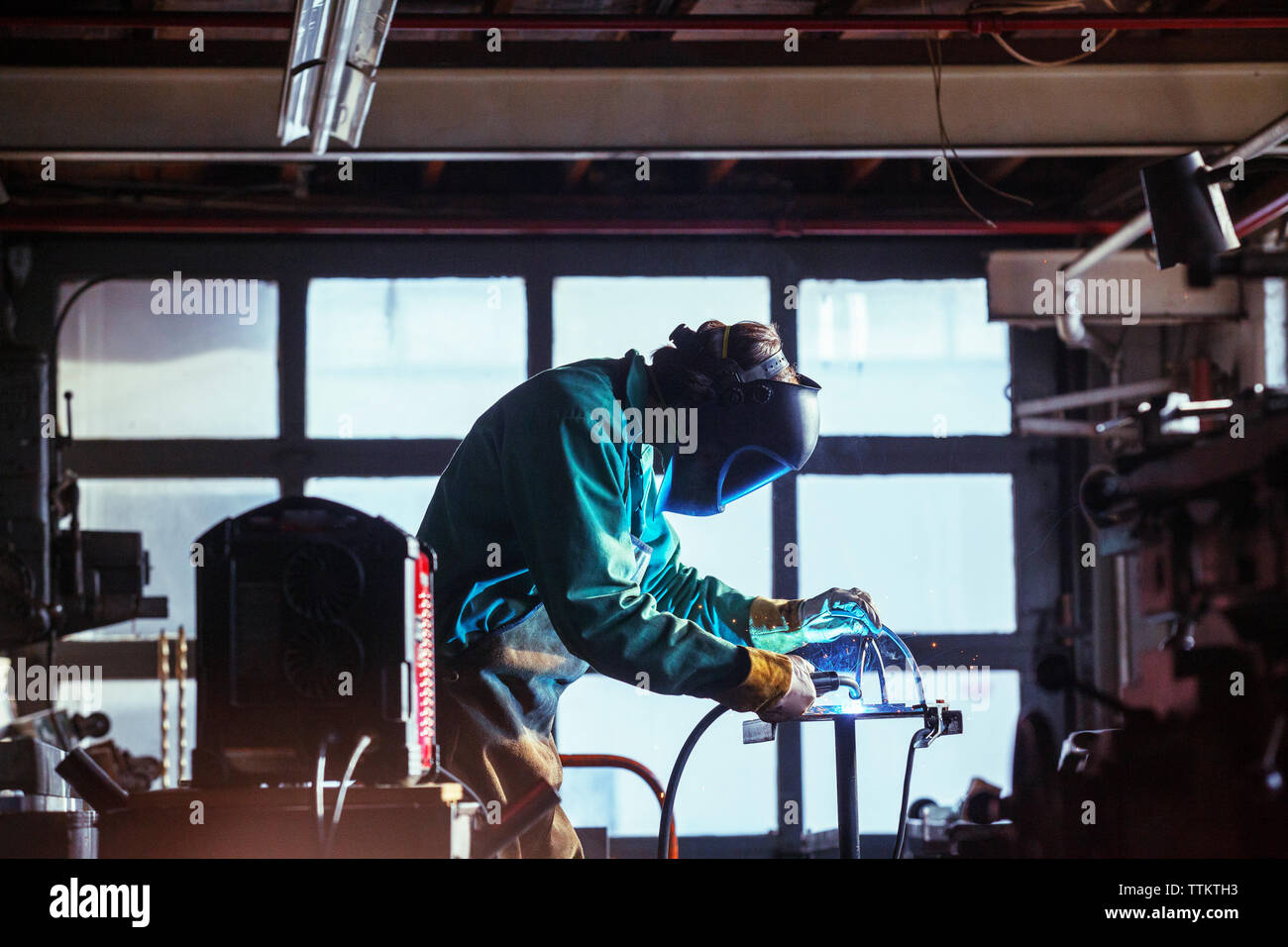 Welder using torch in industrial hi res stock photography and images