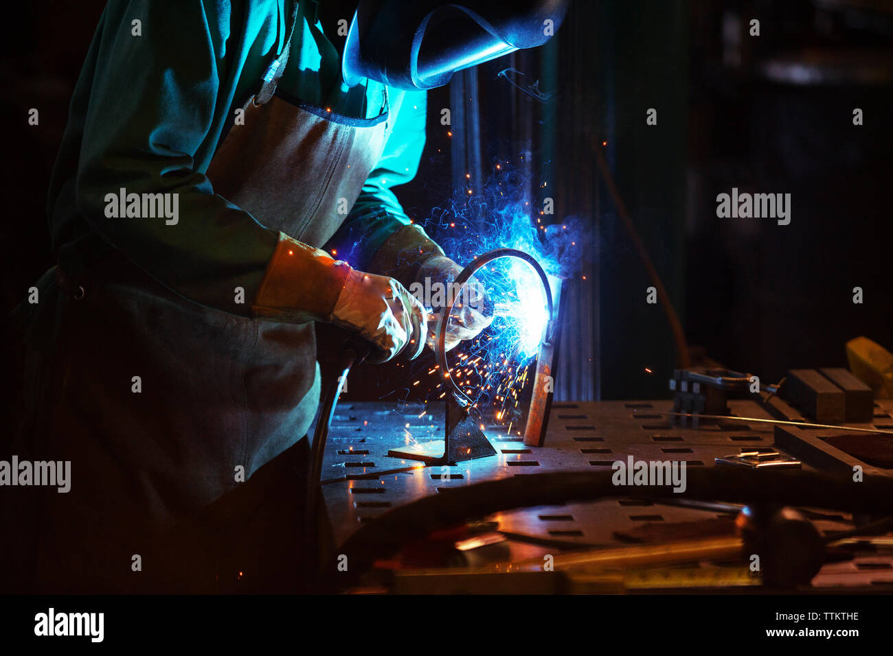 Manual worker welding in workshop Stock Photo