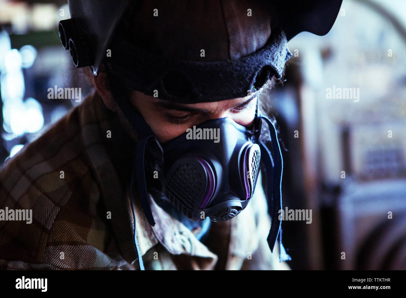 Worker in protective workwear at workshop Stock Photo