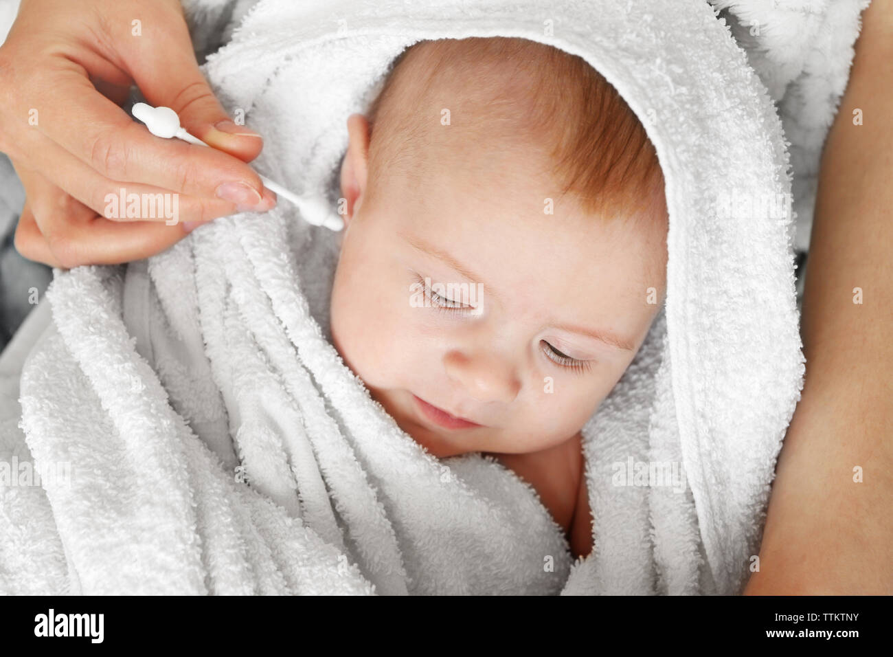 Cleaning small baby ears Stock Photo Alamy