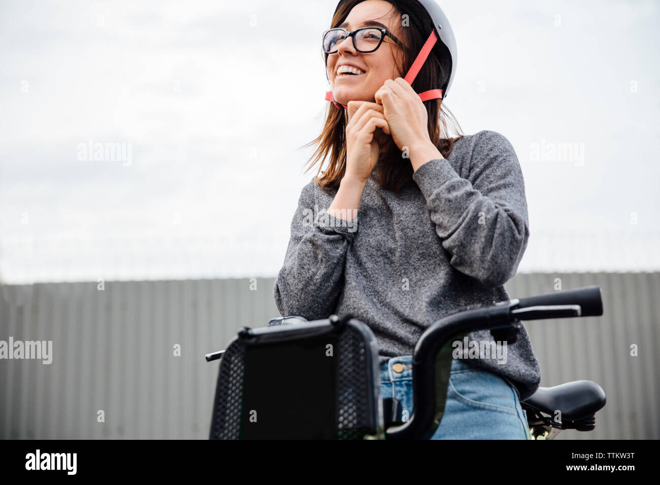 Smiling young woman wearing helmet hi-res stock photography and images ...