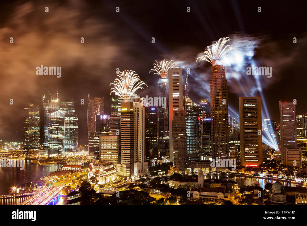 Skyscraper Exploding Fireworks exploding over skyscrapers at illuminated cityscape Stock ...