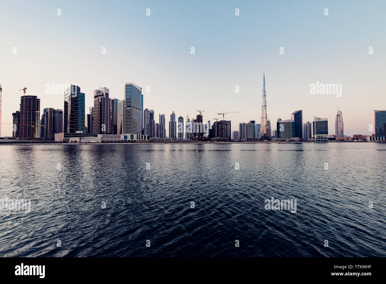 Cityscape and Dubai creek against clear sky Stock Photo