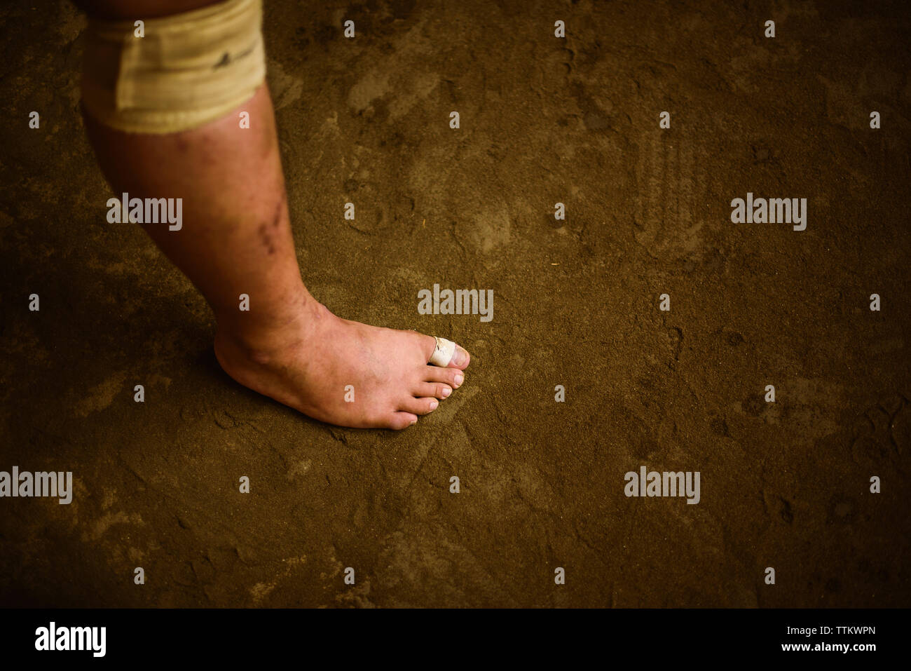 Low section of wrestler standing on sand in sumo beya Stock Photo