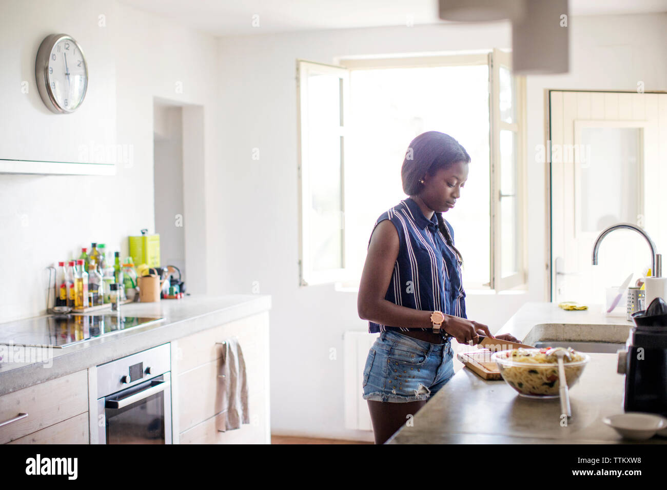 Woman preparing food in kitchen Stock Photo