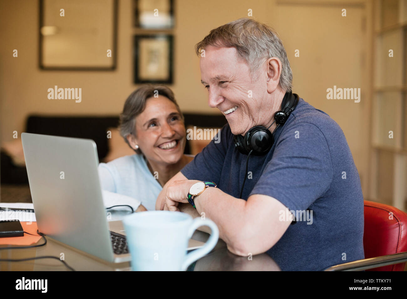 Cheerful couple home using hi-res stock photography and images - Alamy