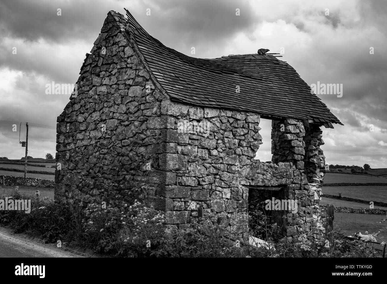 Old Derelict and Abandoned Stone Barn Building in a field near