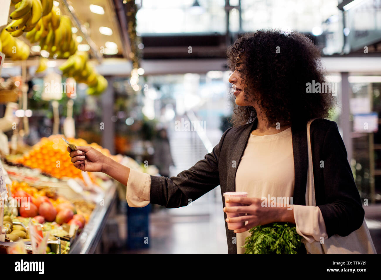 Woman purchasing juice at shop Stock Photo