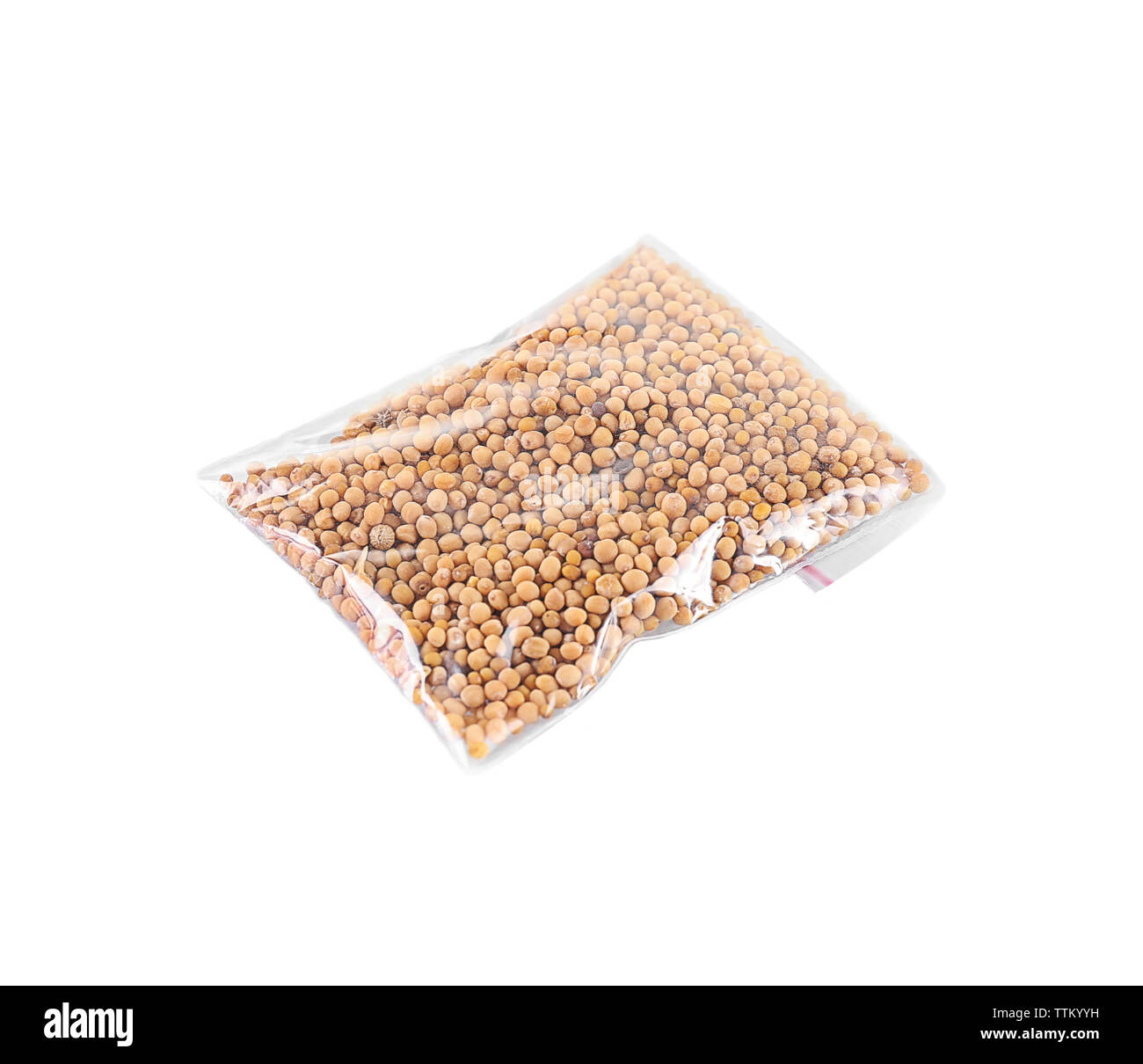 Mustard seeds in plastic zipper bag, isolated on white Stock Photo