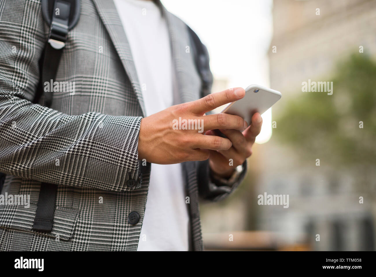 Midsection of businessman using smart phone Stock Photo