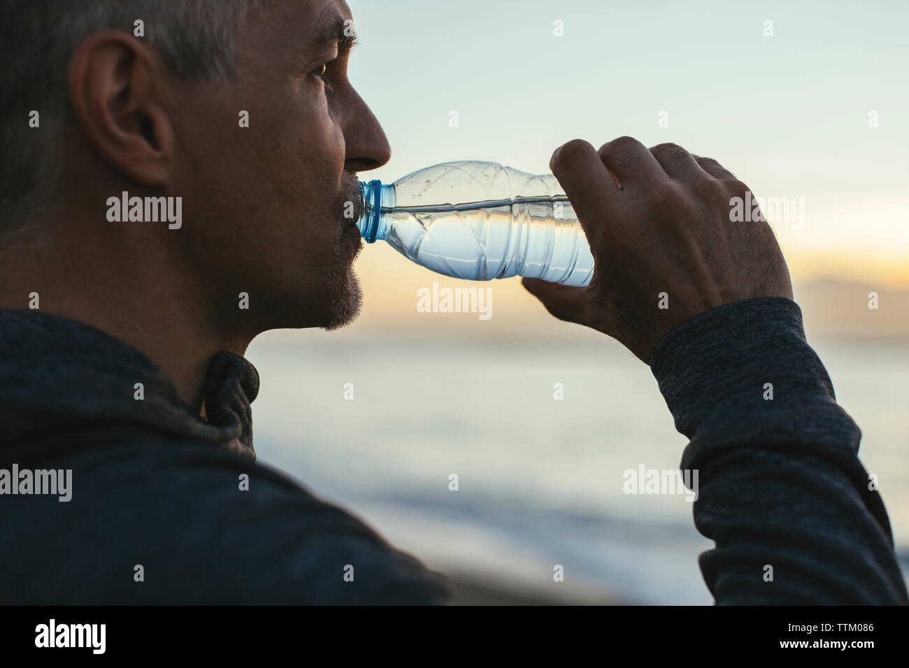 Beach man drinking hi-res stock photography and images - Alamy