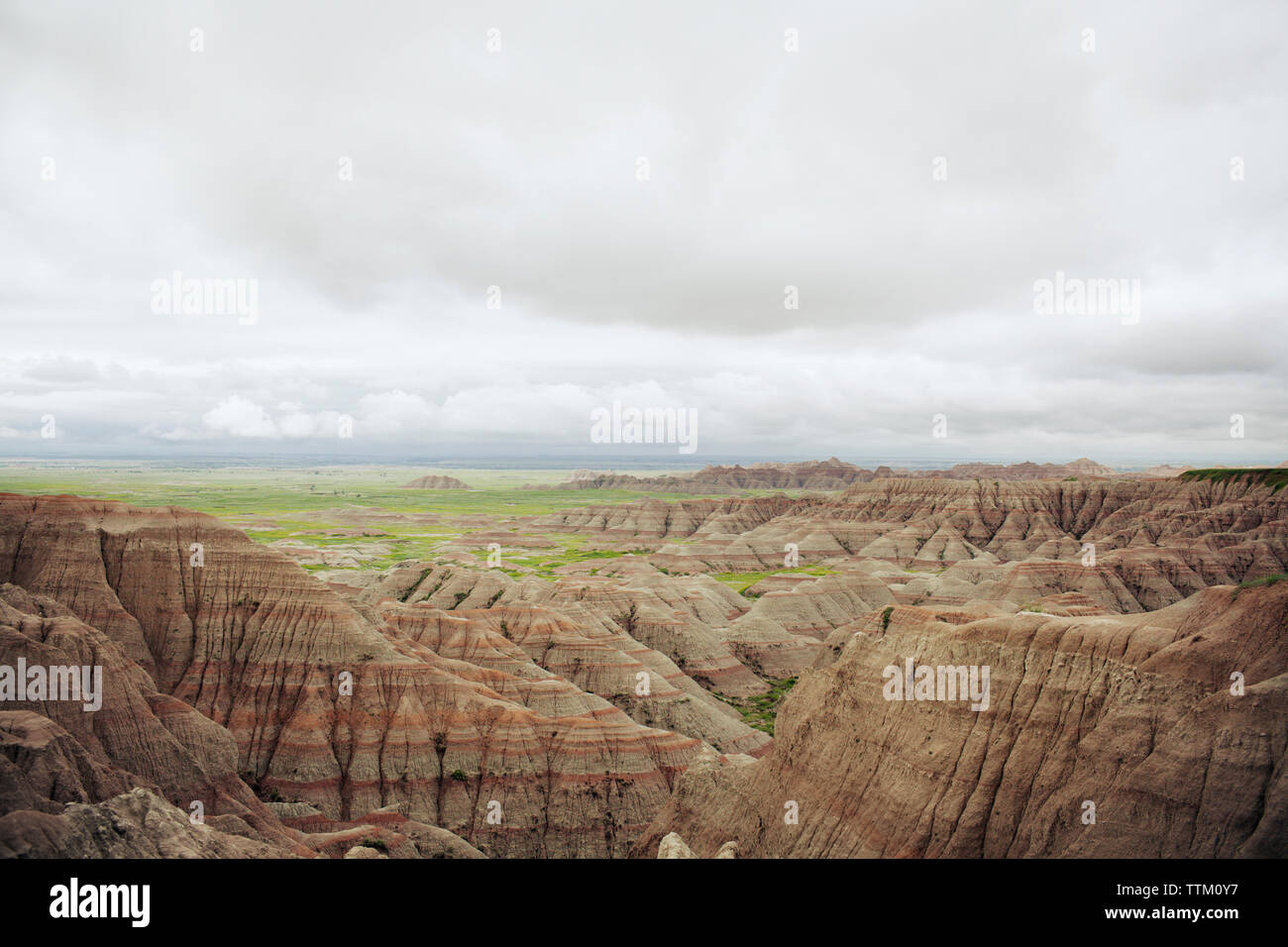 Scenic view of rock formations at Badlands National Park against cloudy ...