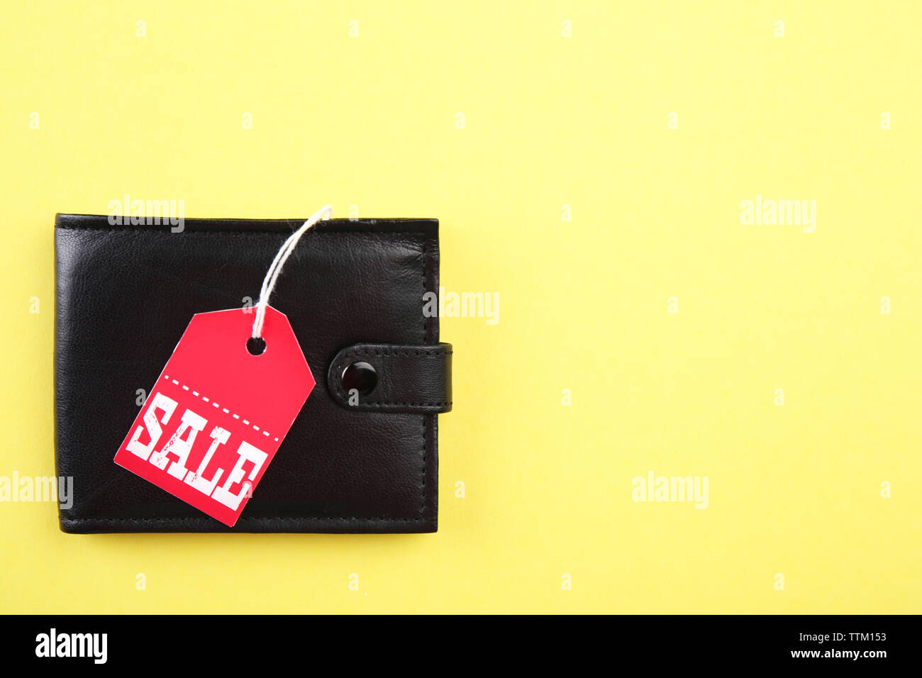 Wallet with sale tag on yellow background Stock Photo