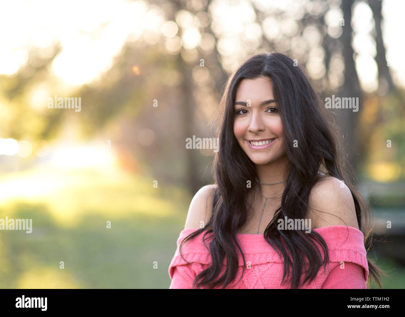 Beautiful brunette girl in pretty light in the woods Stock Photo - Alamy