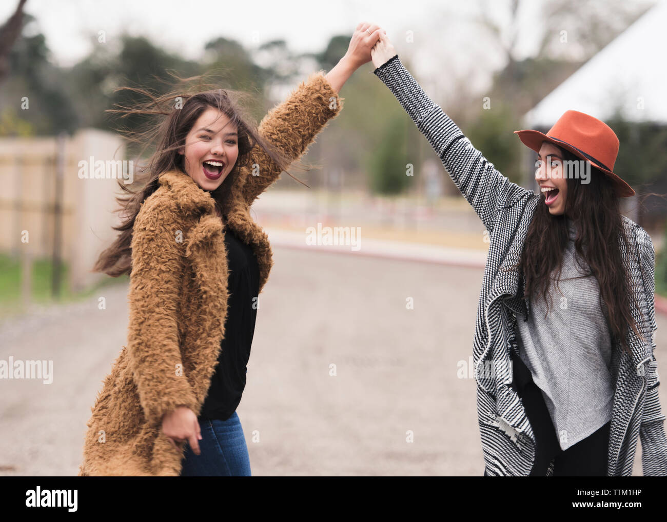 Happy friends dancing in the street. Stock Photo