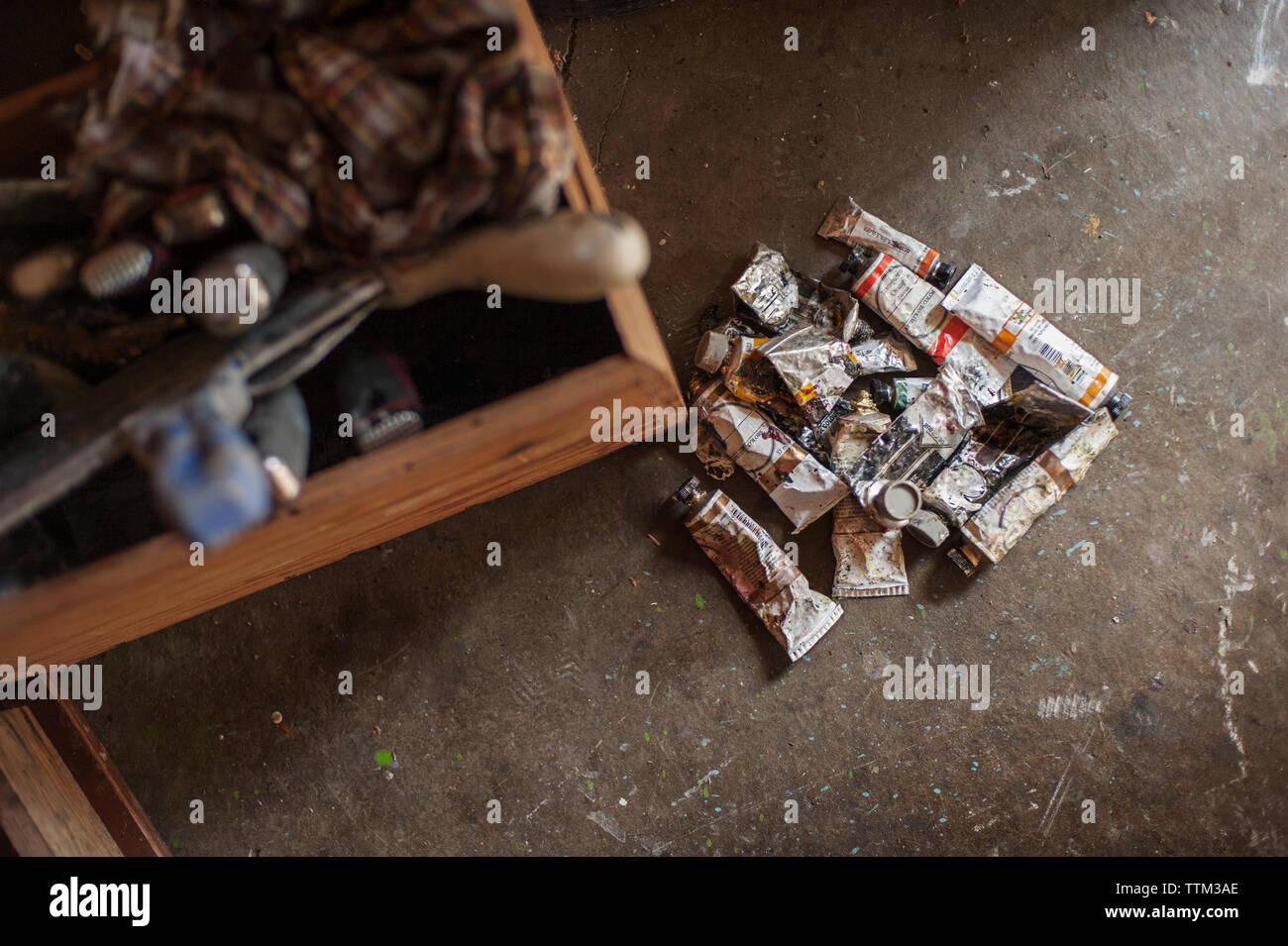Overhead view of paint tubes and drawer at home Stock Photo