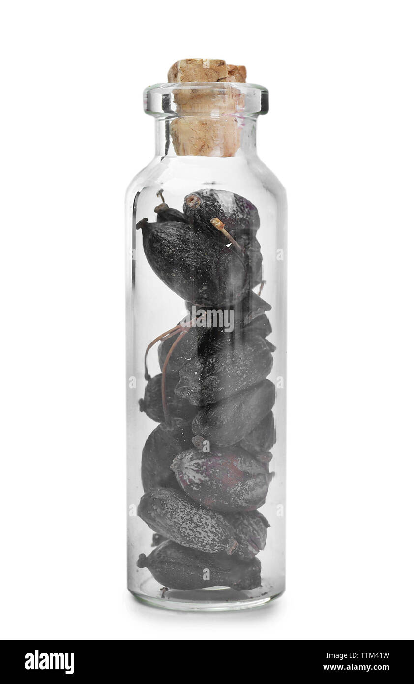 Dried barberry in glass bottle on white background Stock Photo