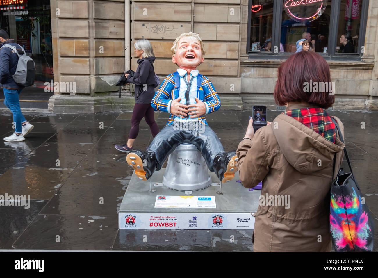 Glasgow, Scotland, UK. 17th June, 2019. Oor Rod, created by Graham Farquhar. This statue is a tribute to Rod Stewart who is a man of many facets: the rock star, the songwriter, the father of eight, the full time curator of one of history's most famous haircuts, the tireless Scottish football fan the football player, Complete with his tartan jacket, signature hairstyle and his most famous song lyrics around the bucket. Oor Rod pays tribute to one of the country's best selling music artists of all time. The sculpture is part of Oor Wullie’s BIG Bucket Trail. Credit: Skully/Alamy Live News Stock Photo
