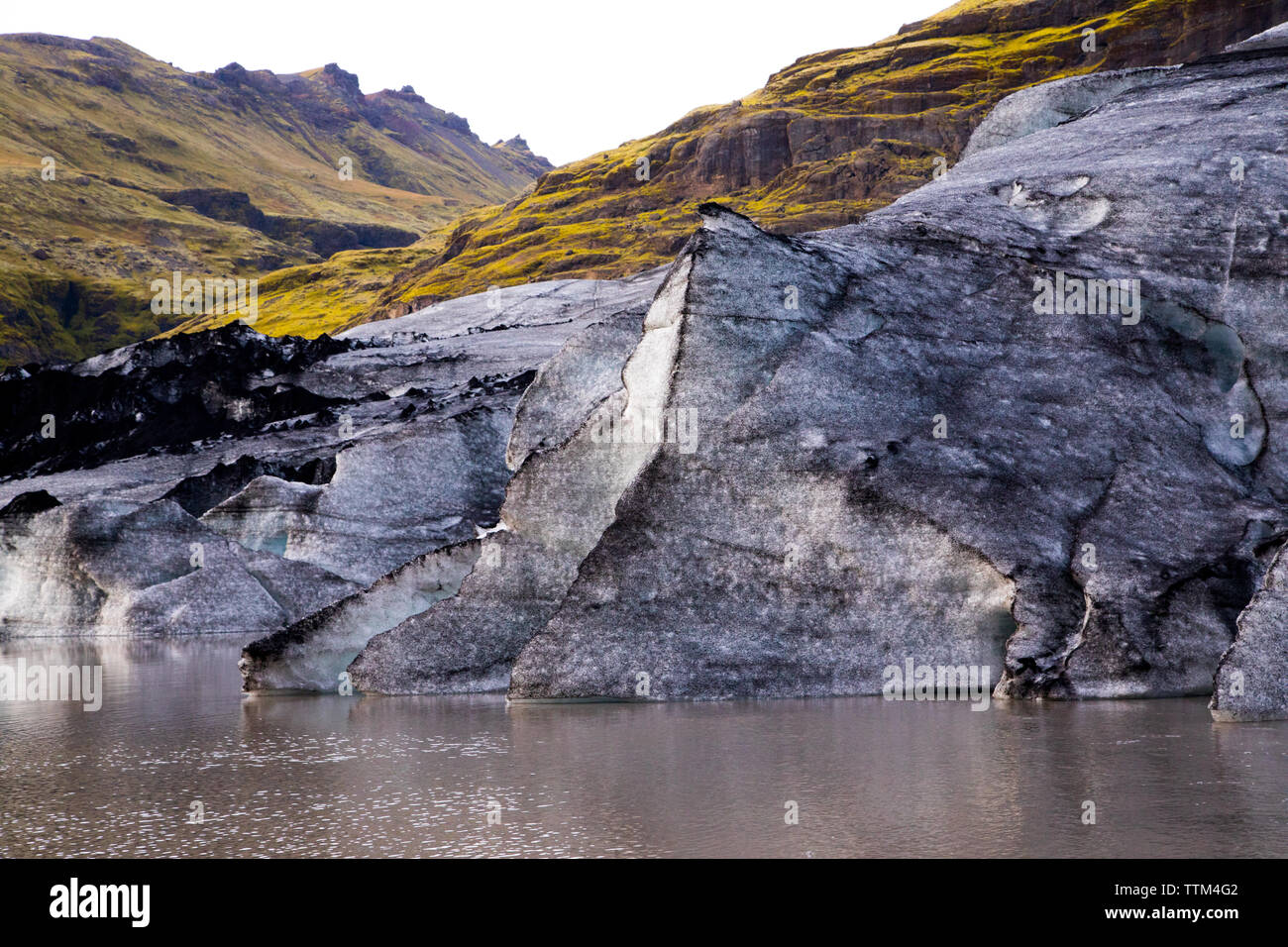 melting glacier with vast green mountains in VatnajÃ¶kull Iceland Stock Photo