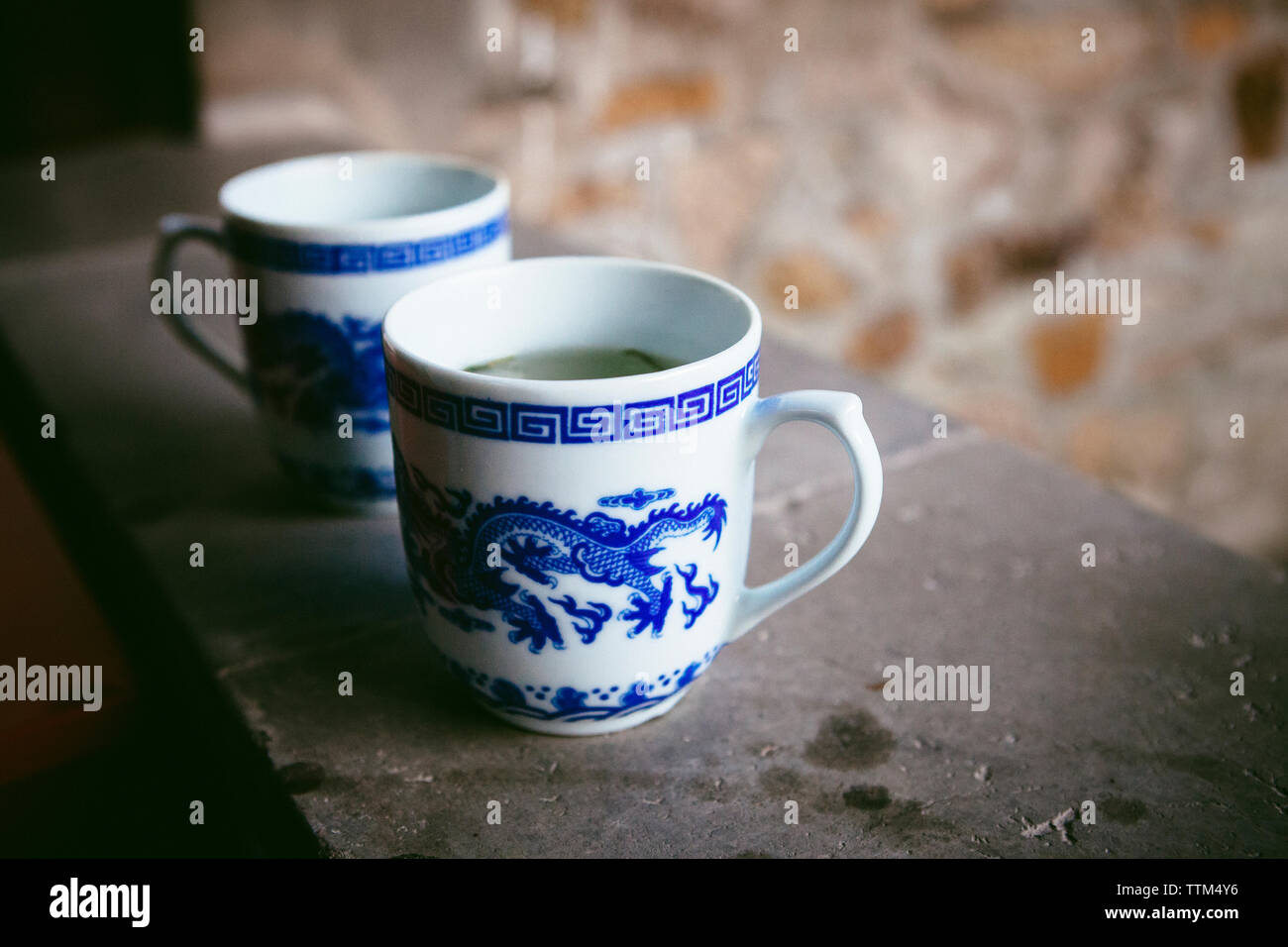 Close-up of tea cups on window sill Stock Photo