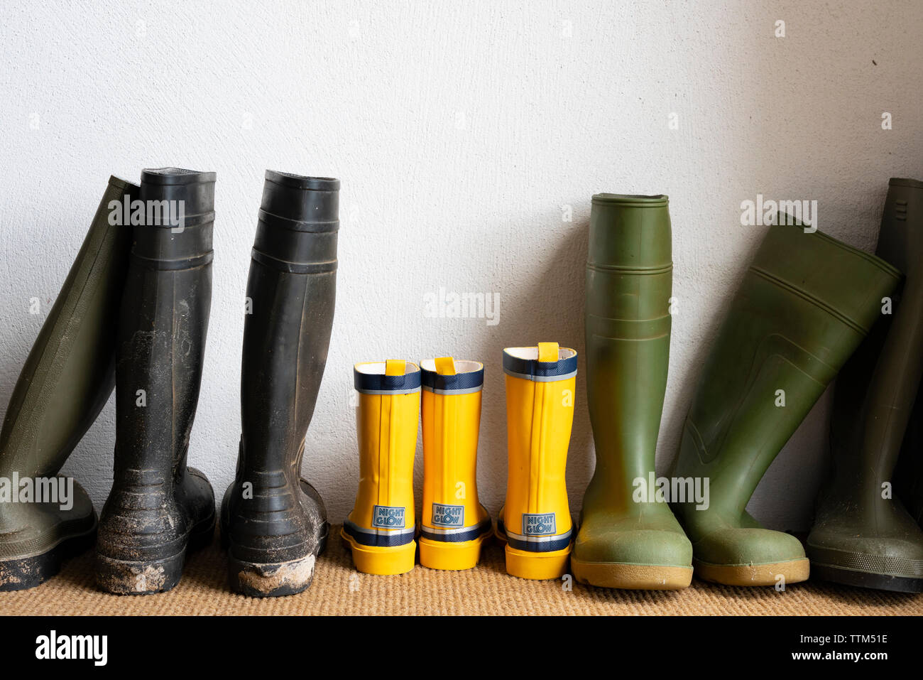 Row of wellington boots in a house Stock Photo