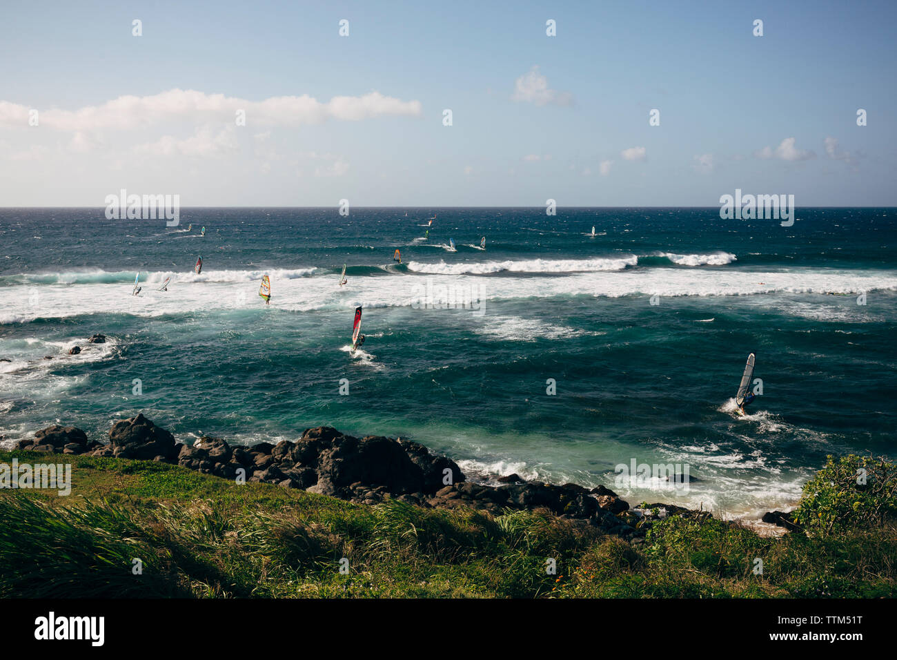 People windsurfing on sea against sky Stock Photo