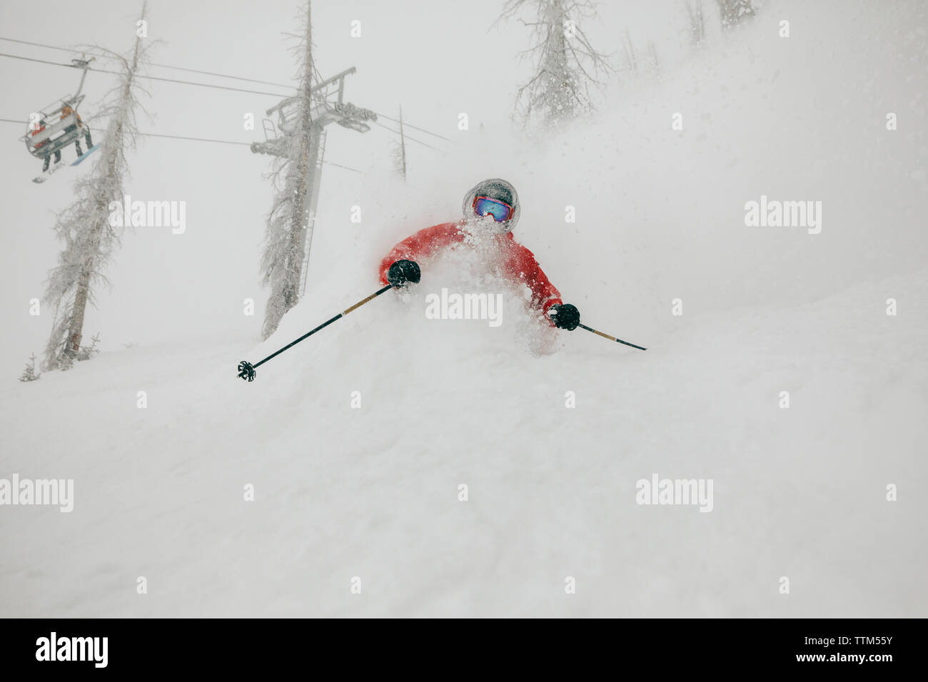 Man skiing on snow covered mountain in forest Stock Photo