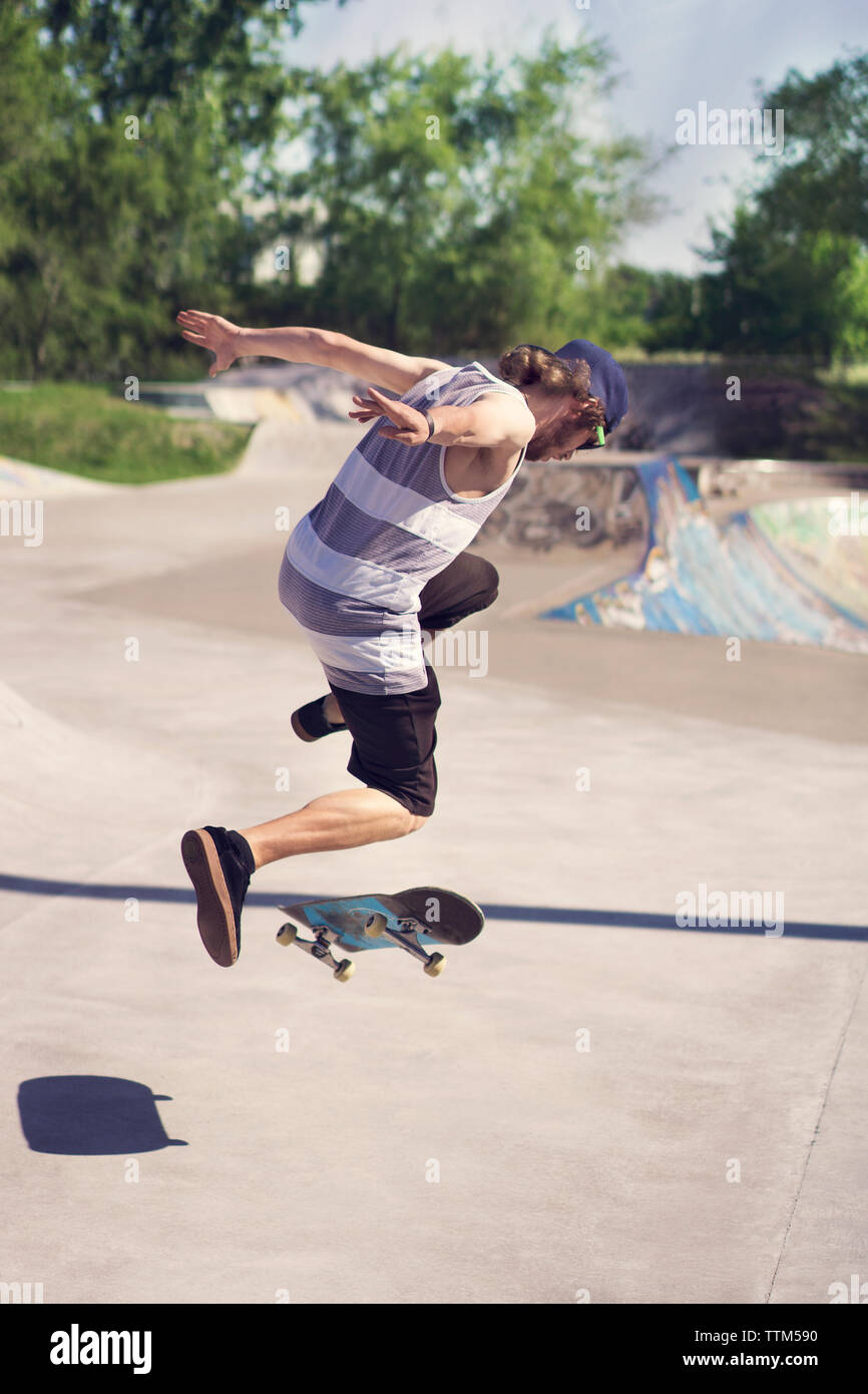 Young man doing skateboard trick on ramp Stock Photo Alamy