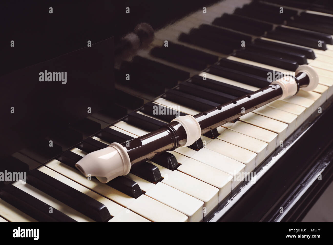 Flute on piano keys, closeup Stock Photo Alamy