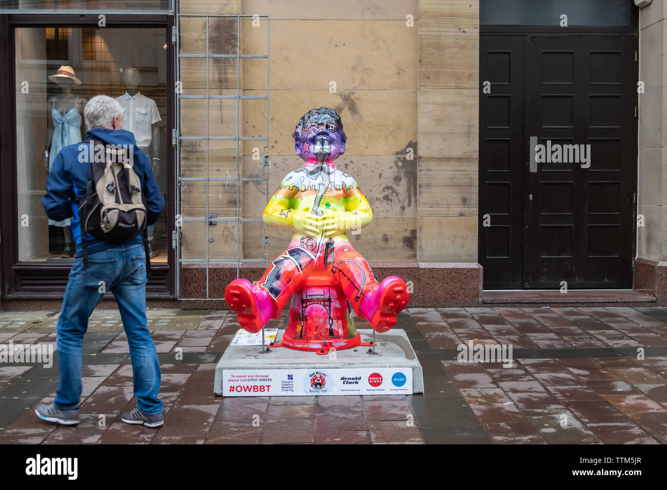 Glasgow, Scotland, UK. 17th June, 2019. Personalities of Glasgow, created by Kris McKinnon. This statue transforms Oor Wullie into a colourful representation of Glasgow, filled with all the iconic landmarks the city has to offer. The sculpture is part of Oor Wullie’s BIG Bucket Trail. Credit: Skully/Alamy Live News Stock Photo