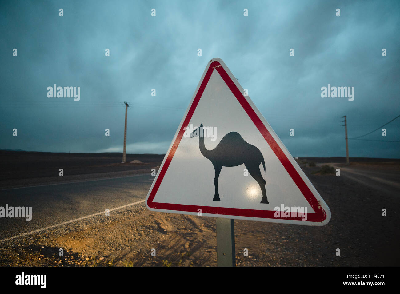 Close-up of road sign on field against cloudy sky Stock Photo - Alamy