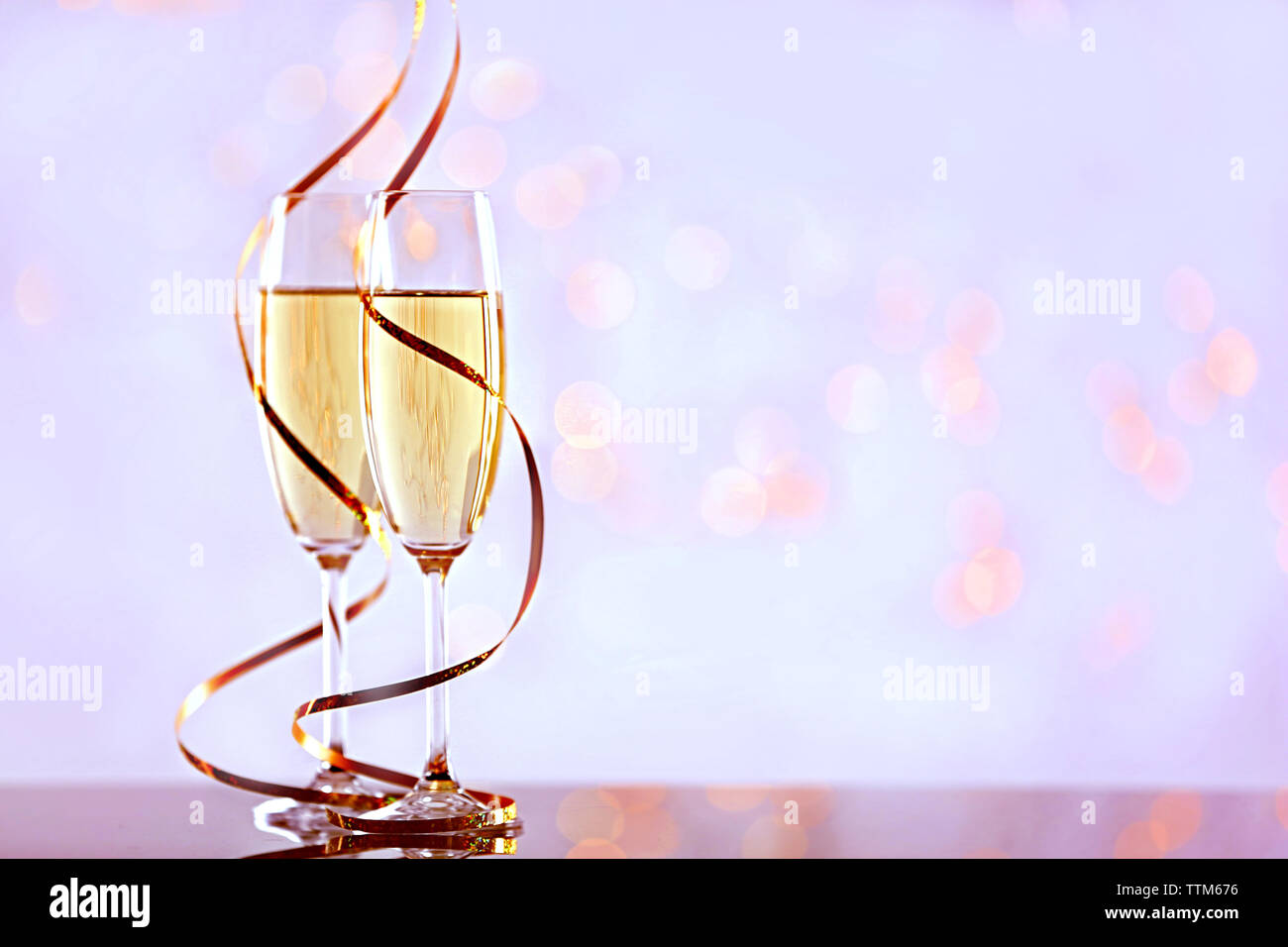 Two champagne glasses with ribbon on light background Stock Photo - Alamy