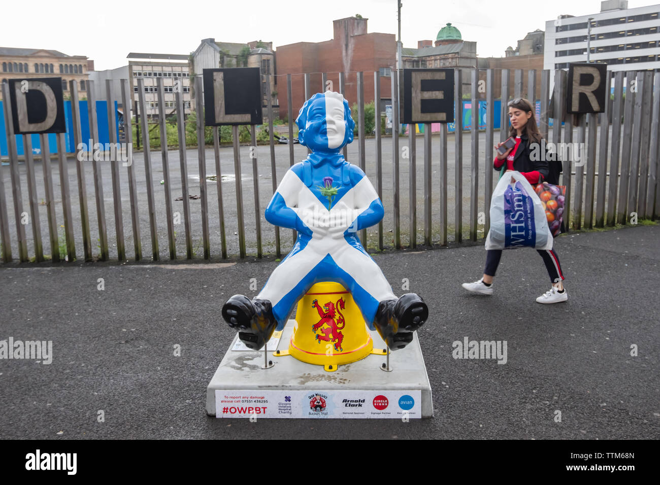 Glasgow, Scotland, UK. 17th June, 2019. Oor People, created by Margaret Fraser. Oor Wullie is sharing his love of his country. Wullie sports the Saltire complete with a thistle in his front pocket, He's also wearing a heart on his back pocket (not on his sleeve), proclaiming his pure love and cheek for his home country. The sculpture is part of Oor Wullie’s BIG Bucket Trail. Credit: Skully/Alamy Live News Stock Photo