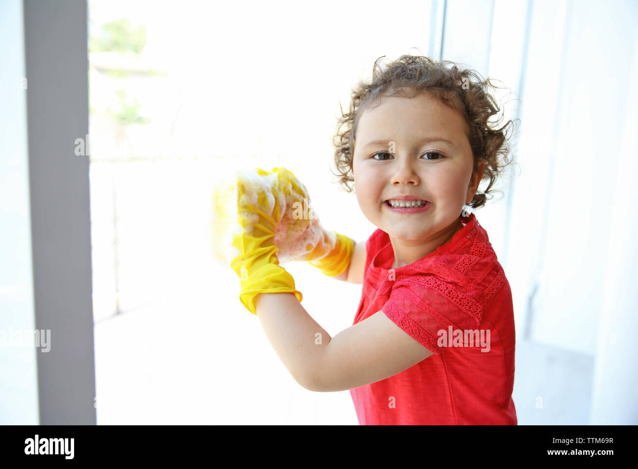 Small cute girl cleaning room Stock Photo - Alamy