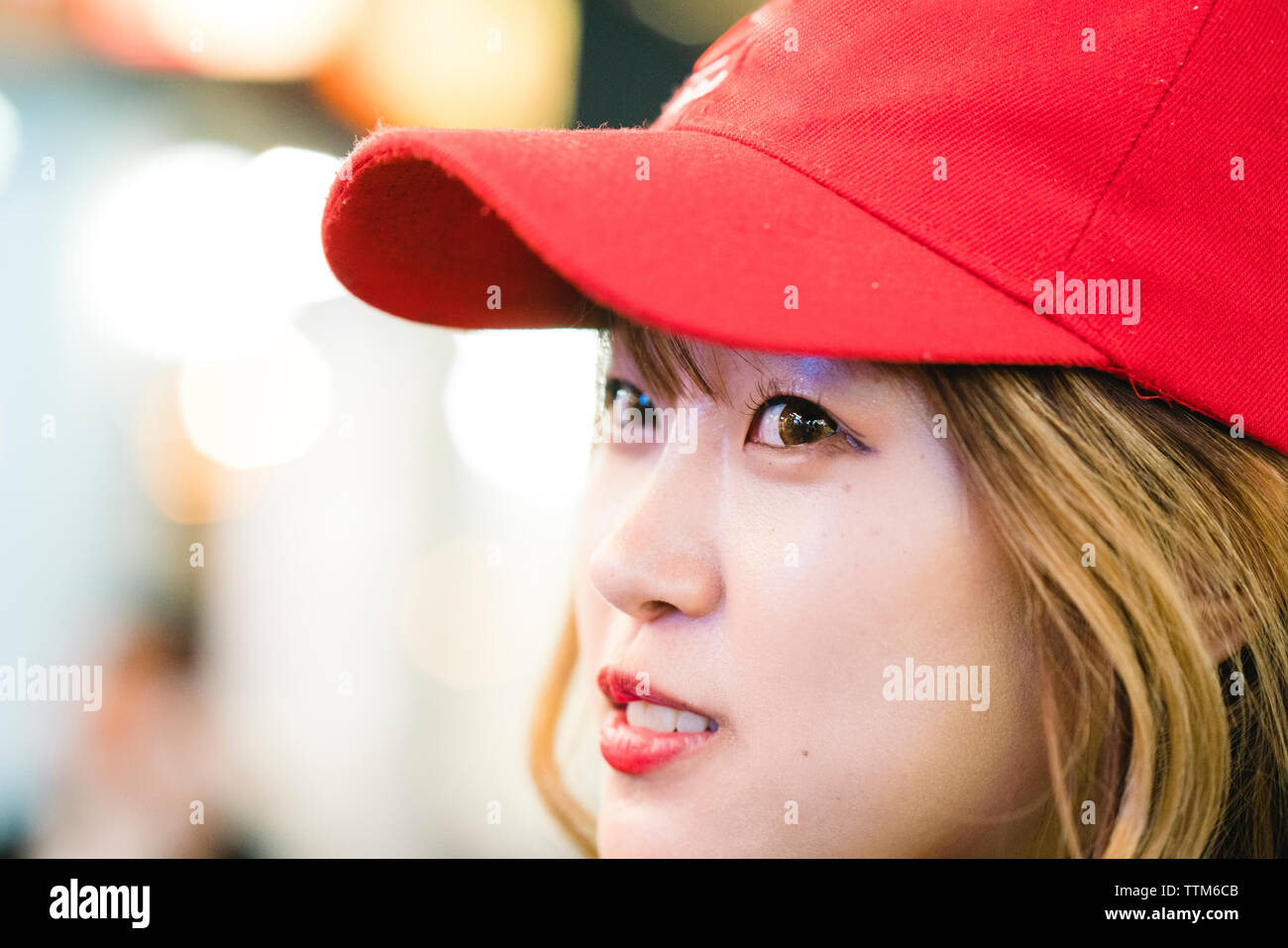 Close-up of thoughtful young woman wearing cap while looking away Stock Photo
