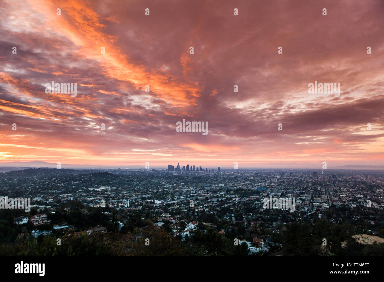 Aerial view of cityscape against cloudy sky during sunset Stock Photo ...
