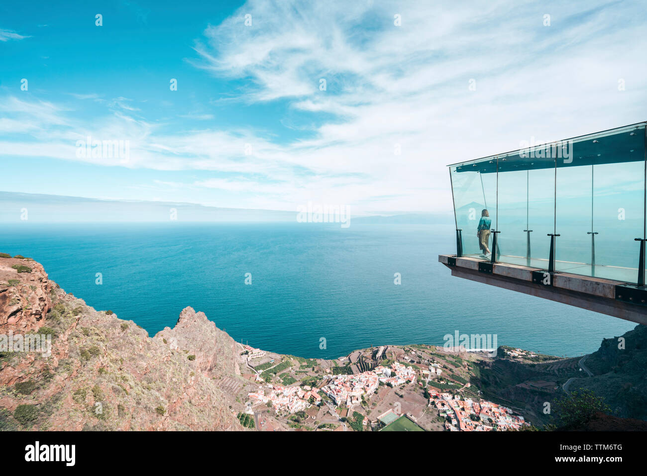 Woman looking at view while standing in Mirador de Abrante against sea during foggy weather Stock Photo