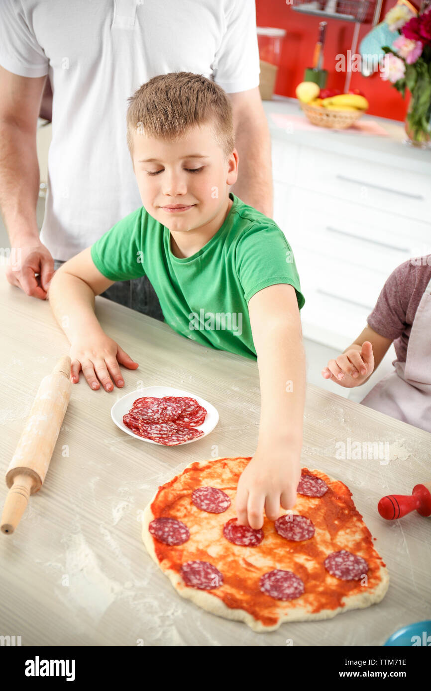 Kids with parents cooking dinner Stock Photo - Alamy
