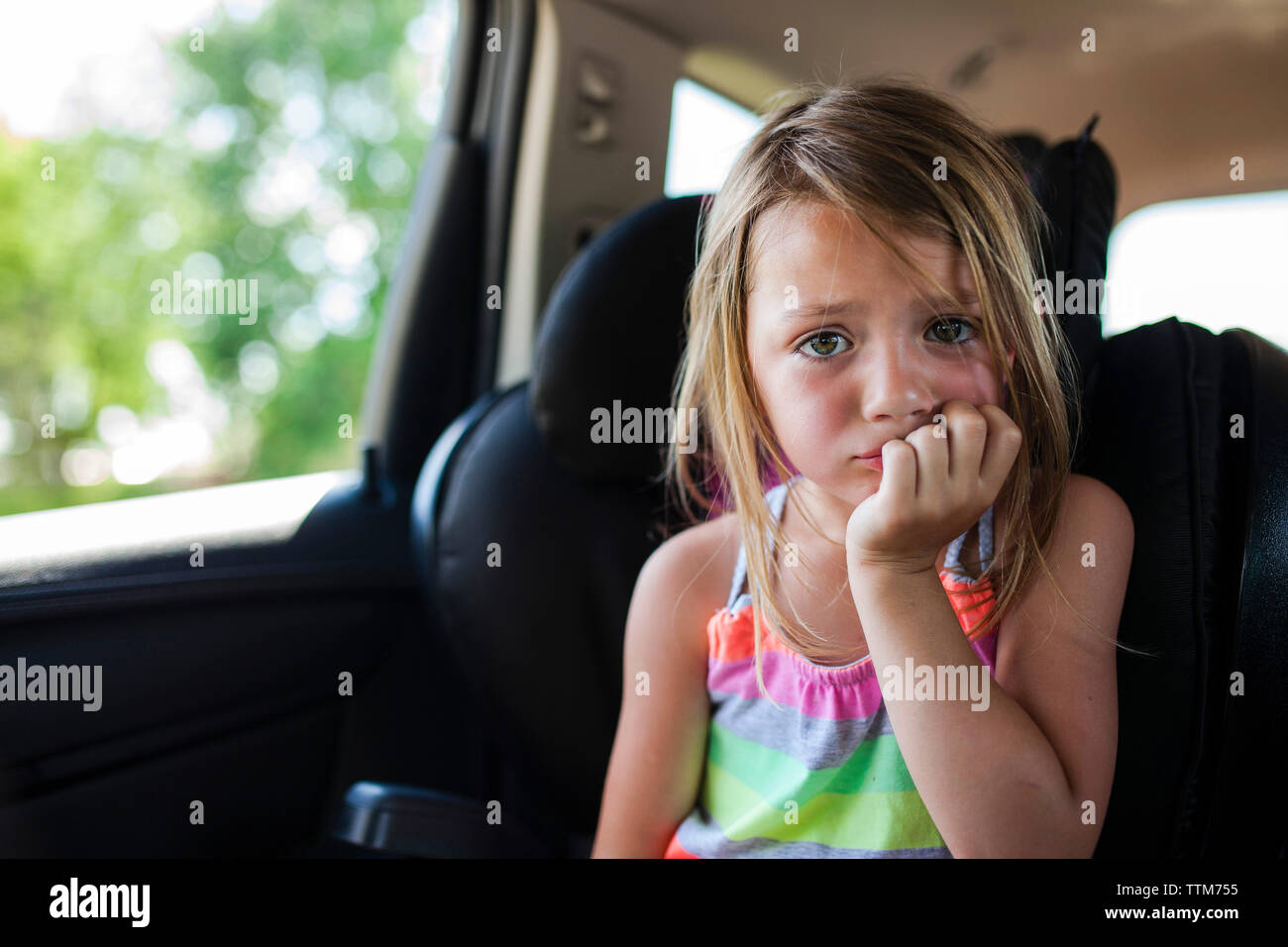 Portrait of upset girl with fingers in mouth Stock Photo